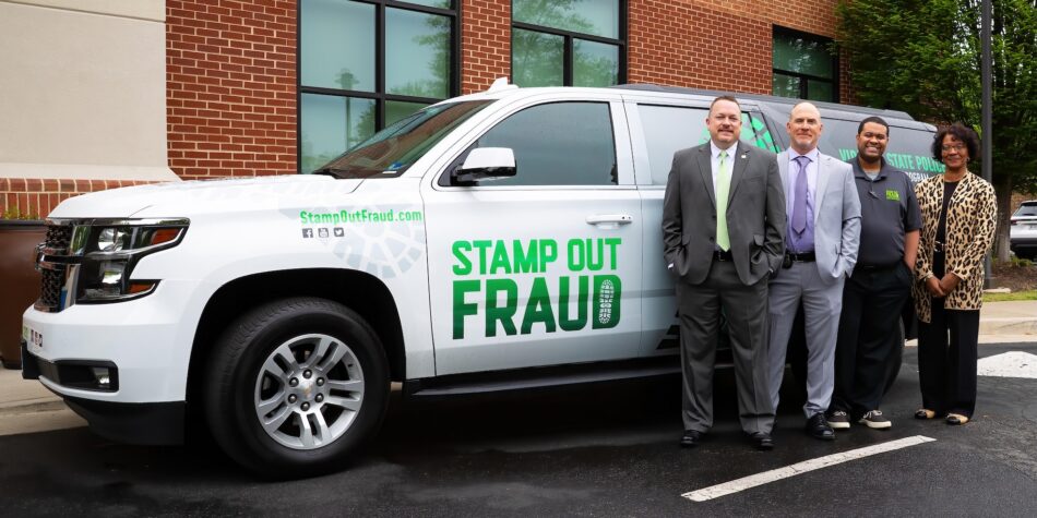 Large SUV with the Stamp Out Fraud logo on the side